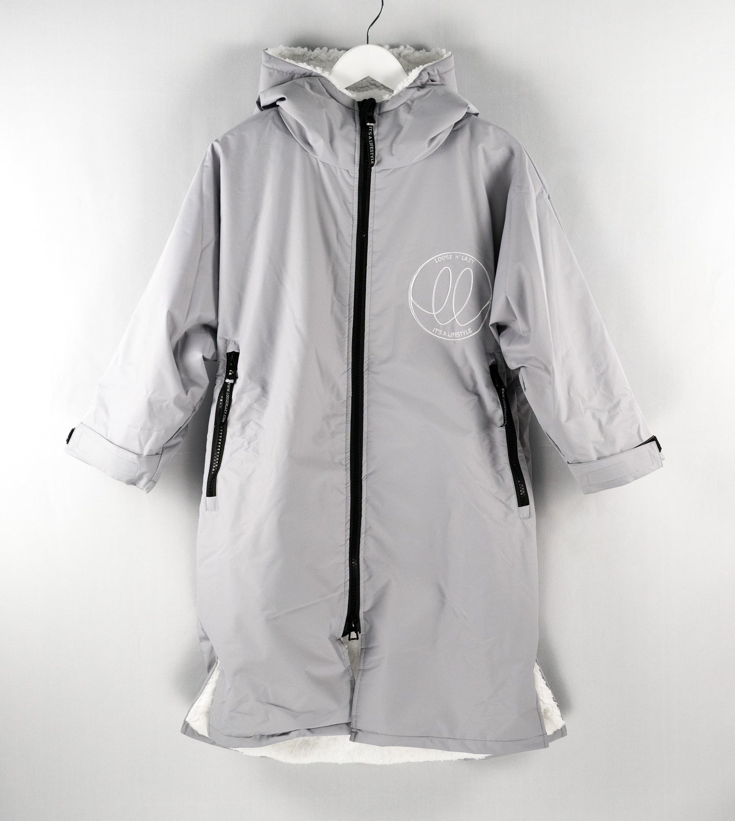 Grey swimming changing robe with white fluffy inner lining.